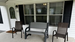 A bench and two chairs in front of a house with a number 2818 on the door. - Kim's Place (Cookeville)