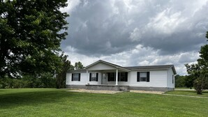 A single-story house with a front porch, a covered entryway, and a well-maintained lawn. - Kim's Place (Cookeville)
