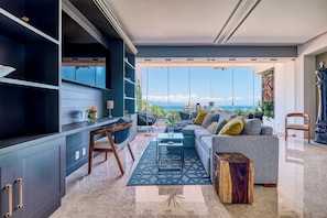 1 Bedroom Suite Deluxe | Living area | 50-inch Smart TV with digital channels, TV