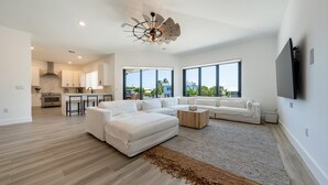 A spacious living area with a large sectional sofa, a coffee table, and a ceiling fan. - ISLAMORADA DREAM (Islamorada)