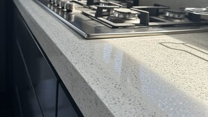 A kitchen with a stainless steel stove and a countertop.