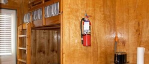 A wooden wall with a fire extinguisher mounted on it. - Hideaway RV Resort (Socastee)