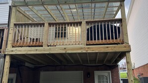 A two-story house with a covered balcony and a garage.