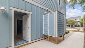 A house with a blue exterior, a wooden deck, and a clear sky. - Modern Beach Villa|2-Min Walk to Beach + Ping Pong (Emerald Isle)