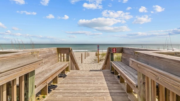 A wooden boardwalk leading to a beach with a clear view of the ocean and sky. - Modern Beach Villa|2-Min Walk to Beach + Ping Pong (Emerald Isle)