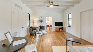 A spacious living room with a ceiling fan, a television, and a dining area with a table and chairs. - Sip, Fish & Relax Fireside: Serene Schulenburg Gem (Schulenburg)