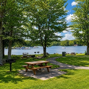 A lakeside park with picnic tables, benches, and a walking path. - Beautiful Lodge in The Hideout!! (Lake Ariel)