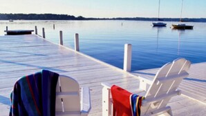 A pier with two white chairs, one with a colorful blanket and the other with a red blanket. - Luxury Property-Walk to lake and downtown Lake Geneva. Pet Friendly, Sleeps 8 (Lake Geneva)