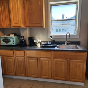 Fridge, microwave, stovetop, coffee/tea maker