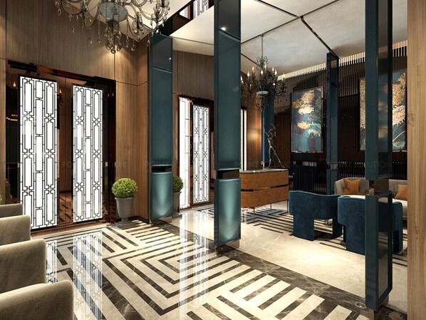 Un lobby moderno con baldosas geométricas en el suelo, mostrador de recepción, zona de estar e iluminación decorativa.