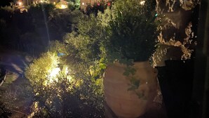 A nighttime view of a residential area with houses and trees. - Charming house in old stone wall village (Fibbiano)