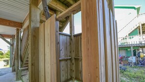A wooden structure with a covered porch and a visible staircase. - Your Slice of Heaven on Topsail Island (Topsail Beach)