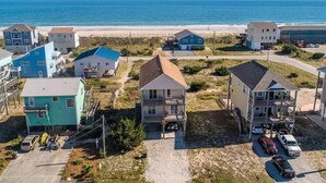 A coastal residential area with houses, a beach, and a clear sky. - Your Slice of Heaven on Topsail Island (Topsail Beach)