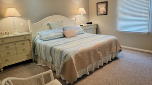 A bedroom with a bed, nightstands, a chair, a window with blinds, and a ceiling fan. - 6 Bedroom ocean block home with private beach access (Bethany Beach)