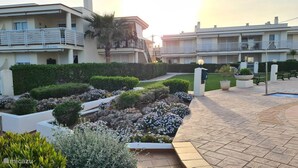 A modern hotel courtyard with a landscaped garden, stone pathways, and a swimming pool. - Mediterranean Lookout From Vinaròs (Vinaròs)