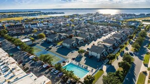 An aerial view of a residential area with houses, a swimming pool, and a tennis court. - Updated 2BR/2BA Condo in North Ocean City, MD | Indoor + Outdoor Pools | 2 Blocks to Beach | Walk to Food Lion & Restaurants | Sleeps 6 (Ocean City)