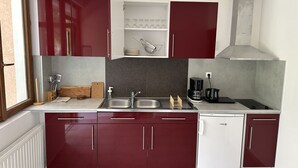 A compact kitchen with a double sink, a coffee maker, and a dishwasher. - Private House (ADA Access) at Domaine de Puygiraud sur L'Anglin for 12-14 guests (Saint-Pierre-de-Maillé)
