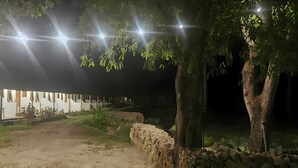 A pathway leading to a building with a white exterior and multiple windows. - THE VILLAGE INN Rua Beach  (Wanokaka)