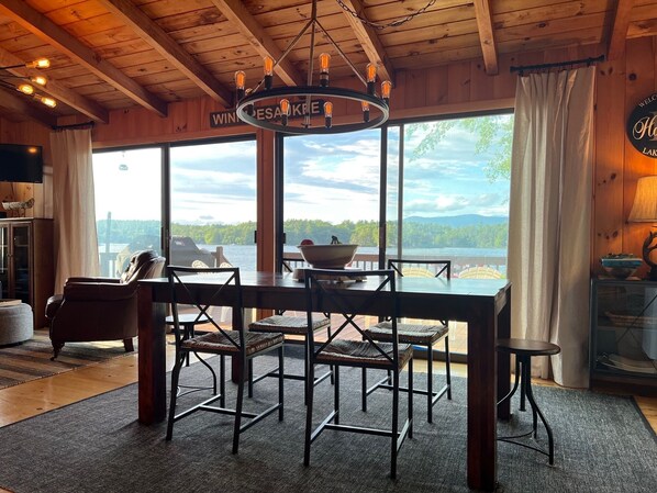 Enjoy a scenic view of the lake and surrounding greenery from this room's large window.