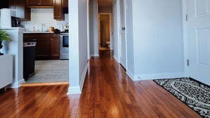 A modern kitchen with wooden cabinets, a built-in oven, and a white tiled backsplash. - Stylish & Central - Walk to UK Campus/Hospital, Mins to DT/Rupp/Keeneland (Lexington)