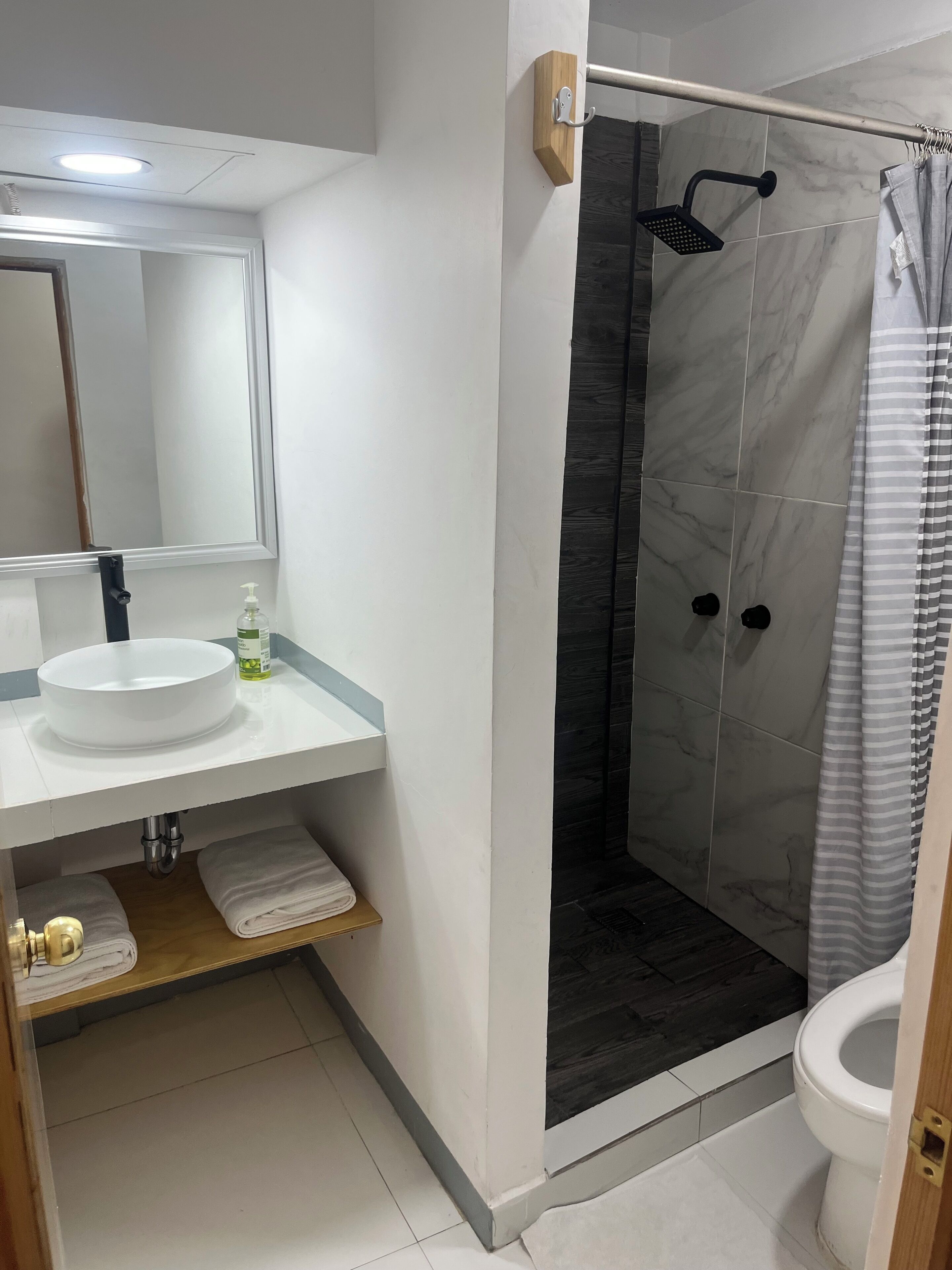 Shower, rainfall showerhead, towels, soap