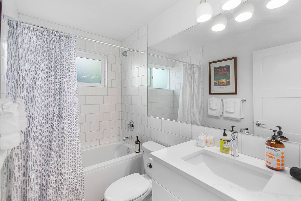 A modern bathroom with a bathtub, toilet, and sink.