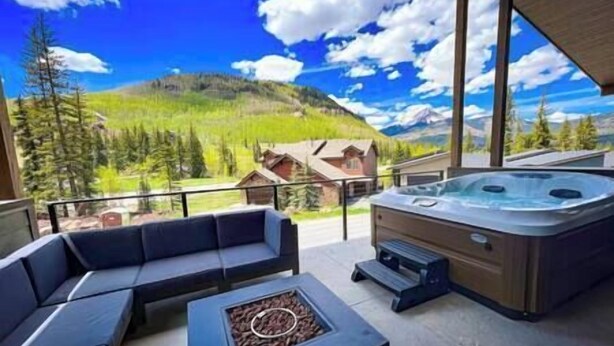 A balcony with a hot tub, seating area, and a fire pit. - Inviting Townhouse at Purgatory (Durango)