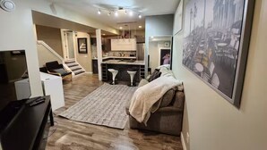A modern interior with a living area, kitchen, and dining space.