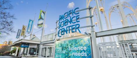 The Pacific Science Center with a prominent sign reading "Science needs women."