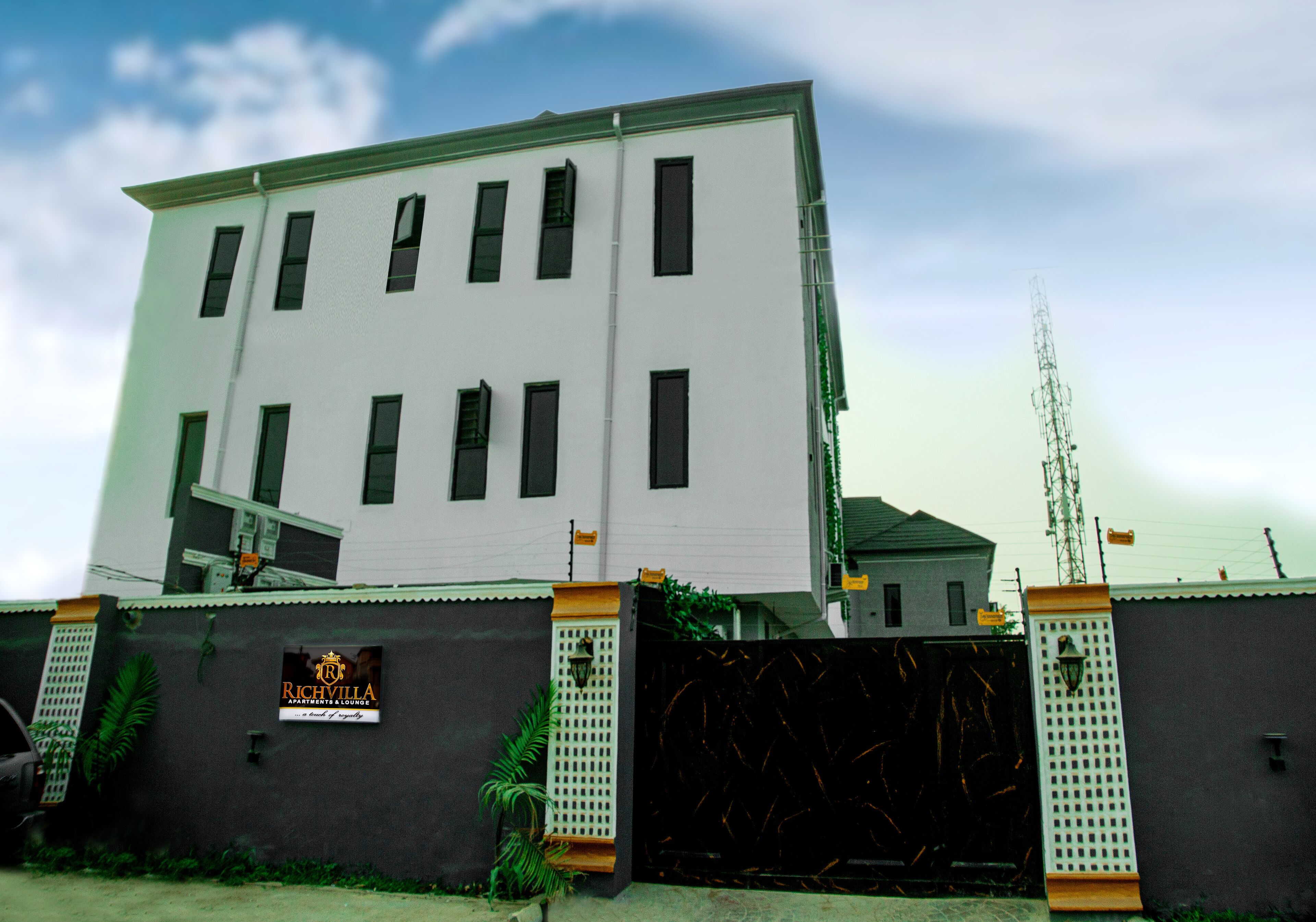 A multi-story building with a sign that reads "Richvilla."