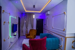 Standard Room | Living area | 75-inch Smart TV with cable channels, TV, fireplace - RichVilla Apartments & Hotels (Lagos)