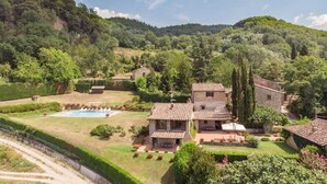 A villa with a swimming pool, surrounded by lush greenery and hills. - Villa Nocella - Private villa with pool in Tuscany (Dicomano)