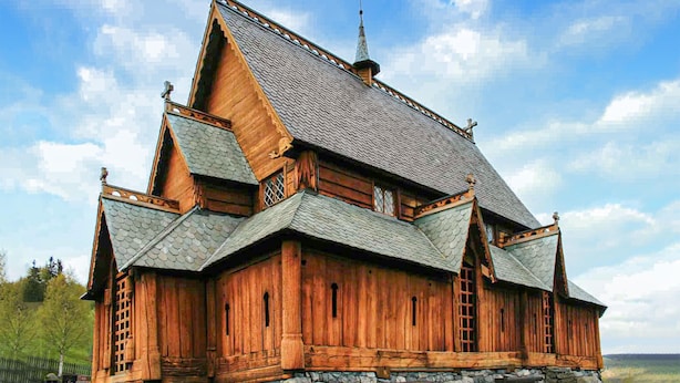 A traditional wooden building with a steeply pitched roof and multiple gables. - Cozy home in Reinli with sauna (Reinli)