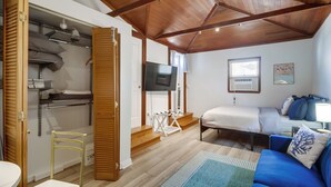 A room with a bed, a blue sofa, a TV, and a wooden ceiling. - Cozy Beach Studio – Sleeps 2, Walk to Ocean (San Diego)