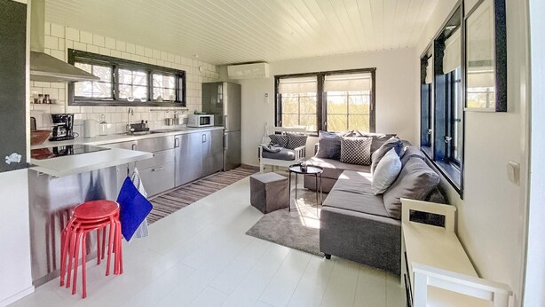 A compact living space with a kitchenette, a sofa, and a dining area. - Gorgeous home in Skivarp with kitchen (Skivarp)