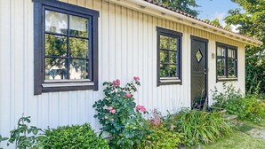 A single-story building with a white exterior and dark window frames. - Gorgeous home in Skivarp with kitchen (Skivarp)