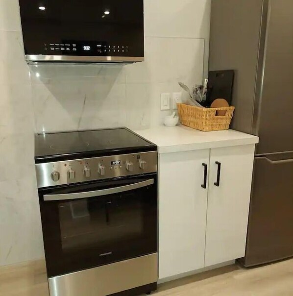A kitchen with a stove, oven, and a refrigerator. - Relax on 4th!
2 yrs old, like new, meticulously clean suite in perfect location! (Saskatoon)