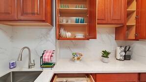 A kitchen with wooden cabinets, a marble countertop, a sink, and a dish rack. - 9 - Peaceful & Spacious 4B2B Upper Unit near FW (Daly City)