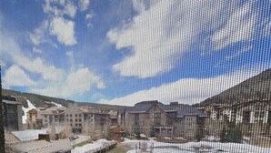 A building with a sloped roof, multiple windows, and a visible entrance. - Village square 442, Center Village Copper Mountain,Pet Friendly includes parking (Copper Mountain)