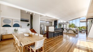 A spacious open-plan living area with a dining table, kitchen, and seating area.