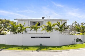 A modern building with a sign indicating it's a holiday rental.