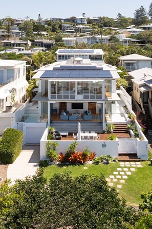 A modern two-story house with a flat roof, large windows, and a solar panel array. - The Beach Shack - Getaway on Sunshine Beach (Sunshine Beach)