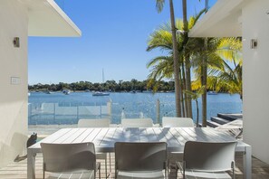 Relax with a view of the marina from this serene outdoor seating area, featuring a table and chairs for a small group.