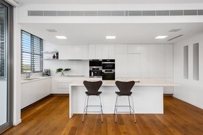 Enjoy cooking in this well-lit kitchen with a central island and oven and microwave.