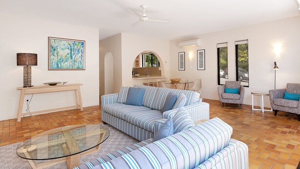 A modern living room with a sofa, armchairs, a glass coffee table, and a dining area with a table and chairs. - Bayona 4 - Balcony Tranquility (Little Cove)