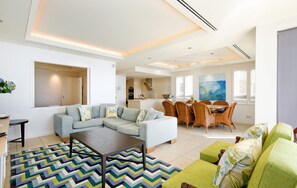 Relax in a stylish living area with a sofa, coffee table, and dining space.