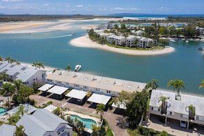 A coastal resort with multiple buildings, a swimming pool, and a marina. - Driftwood 2 - Riverfront with Jetty (Noosaville)