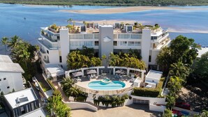 A hotel with a pool, beachfront view, and multiple balconies. - Las Rias, Riverside Luxury Bliss (Noosa Heads)