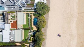 A resort with a pool, beach access, and a large building with a swimming pool.
