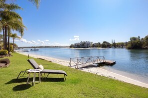 Relax by the serene lake with a lounge chair and table, or try your hand at fishing from the wooden dock.